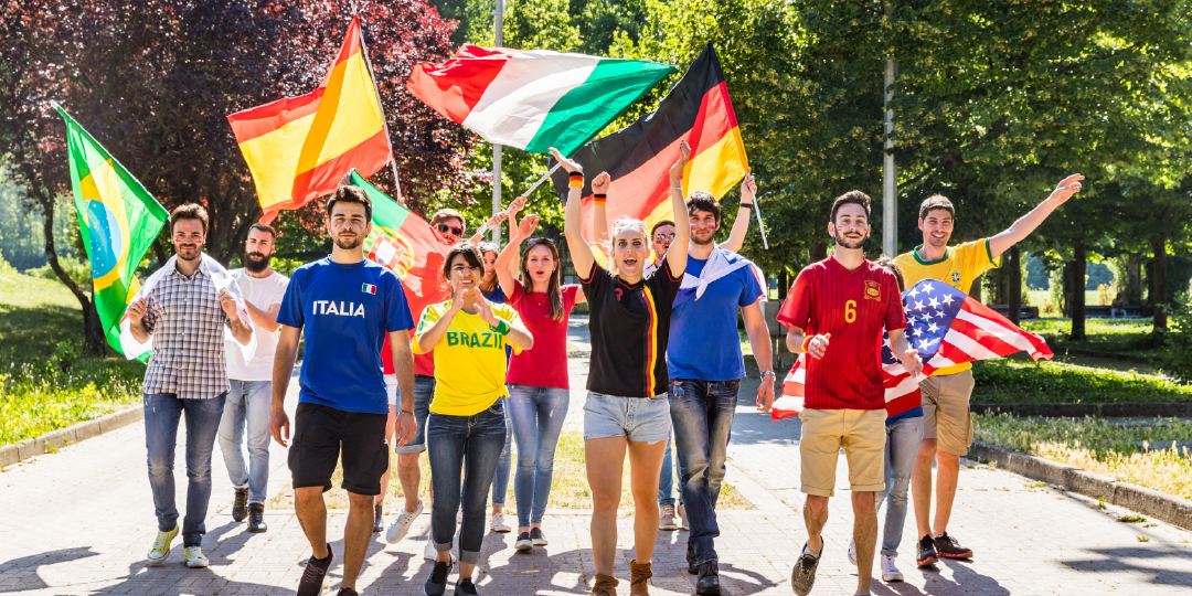 group of people waving various international flags 
